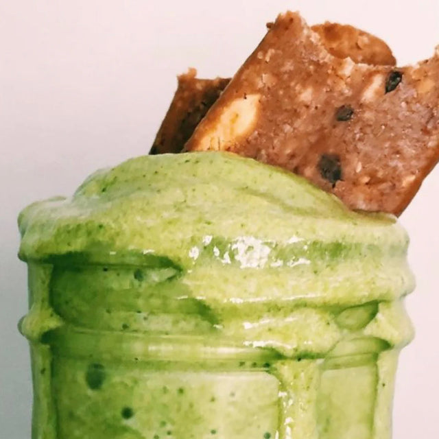 Green mango and spinach smoothie topped with pieces of G2G bar
